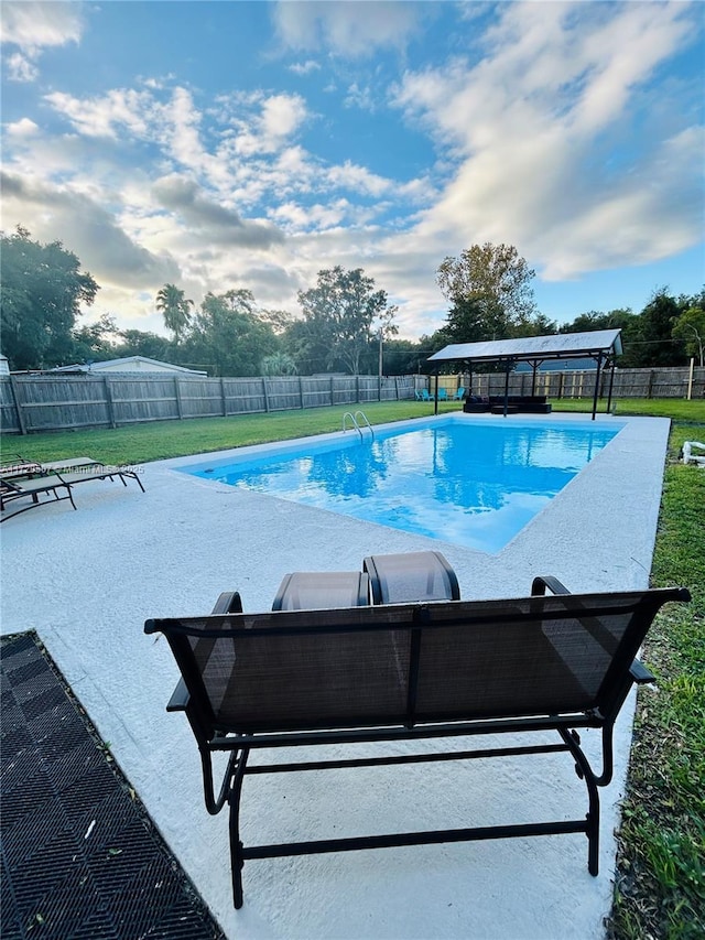 view of swimming pool with a lawn and a patio