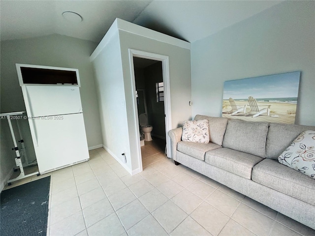 unfurnished living room featuring light tile patterned floors and lofted ceiling