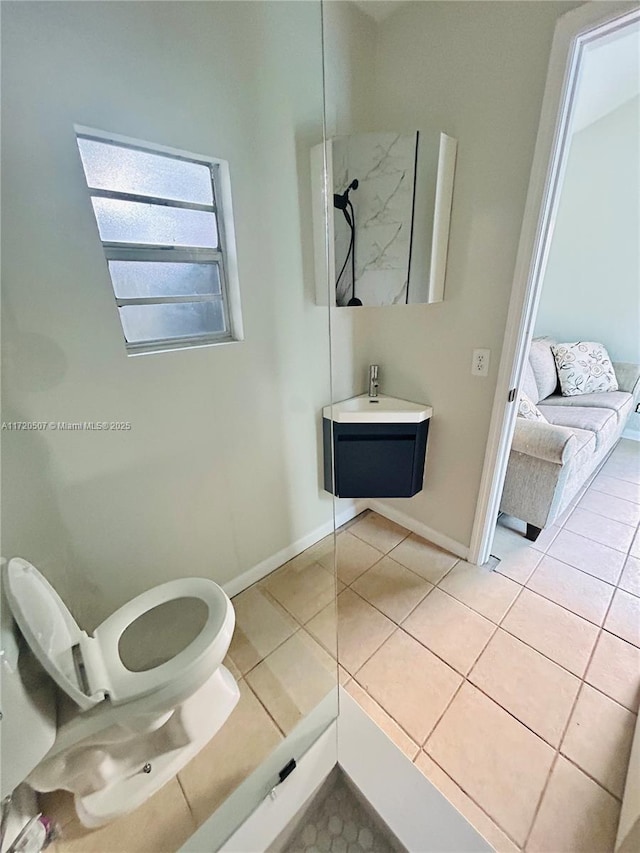 bathroom with tile patterned flooring, vanity, and toilet