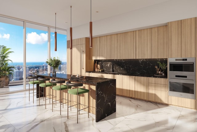 kitchen featuring a breakfast bar, sink, hanging light fixtures, double oven, and tasteful backsplash