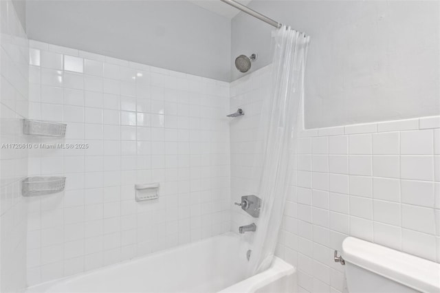 bathroom with shower / tub combo with curtain, tile walls, and toilet