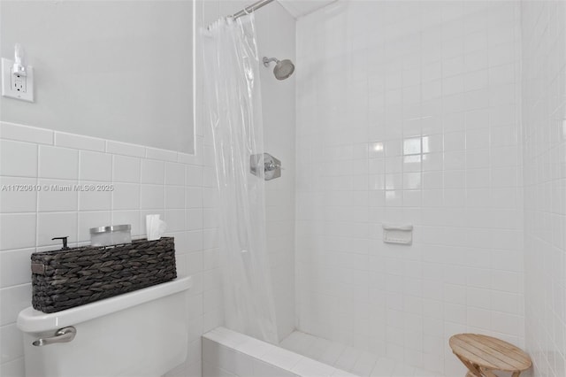 bathroom with walk in shower and tile walls