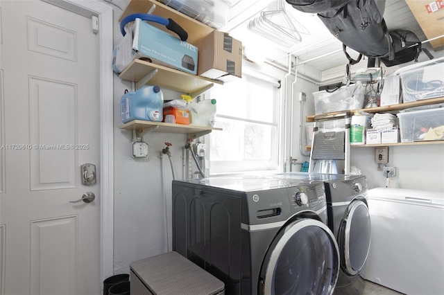 clothes washing area featuring separate washer and dryer