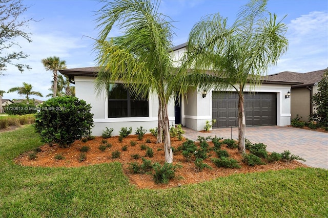 view of front of home featuring a front yard and a garage