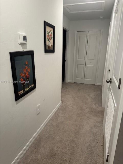 hallway with light colored carpet