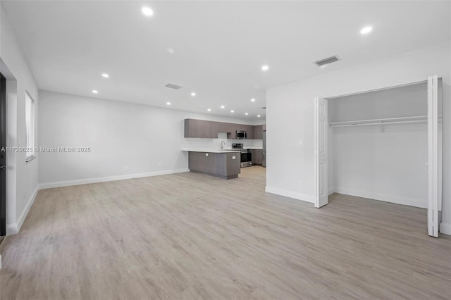 unfurnished living room featuring light hardwood / wood-style flooring