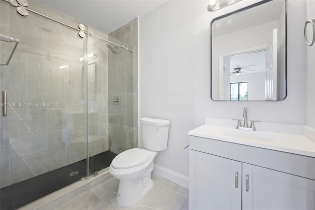 bathroom with vanity, a shower with door, toilet, and ceiling fan