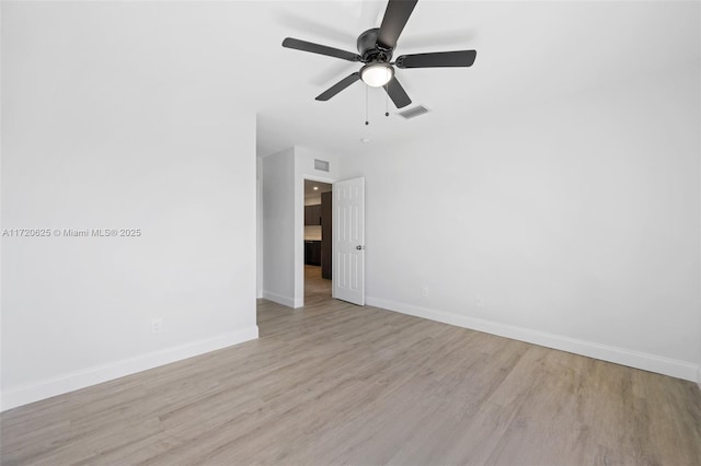 empty room featuring light wood-type flooring and ceiling fan