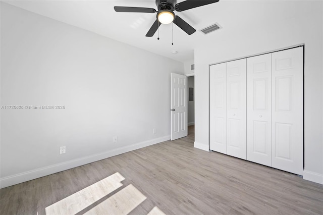 unfurnished bedroom featuring light wood-type flooring, a closet, and ceiling fan