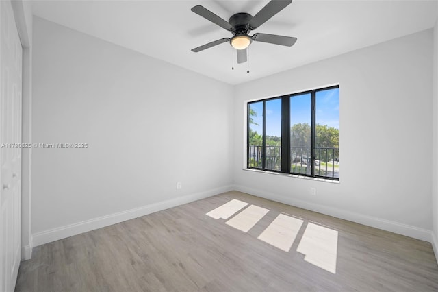 spare room featuring ceiling fan and light wood-type flooring