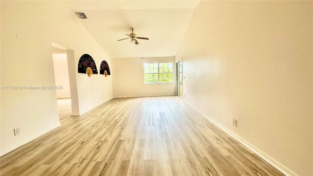 empty room featuring ceiling fan, high vaulted ceiling, and light hardwood / wood-style flooring