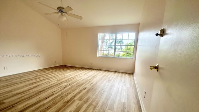 empty room featuring ceiling fan, light hardwood / wood-style floors, and lofted ceiling