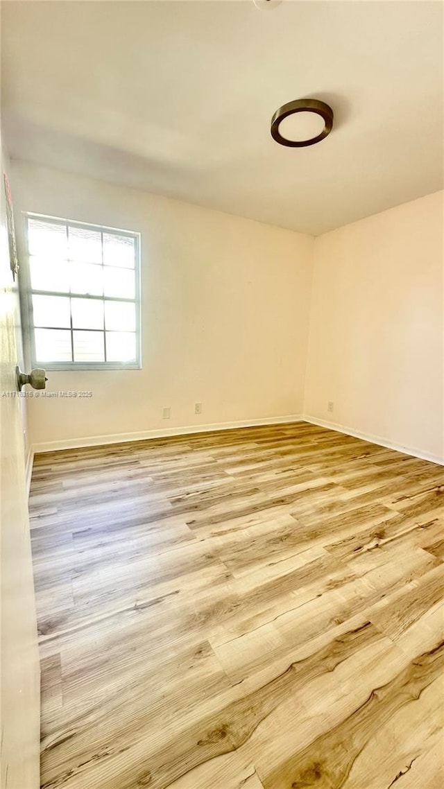 unfurnished room with light hardwood / wood-style floors