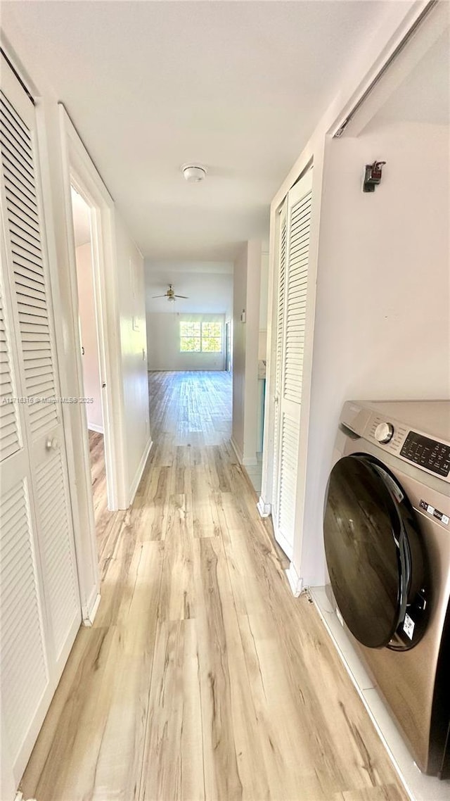 hallway featuring washer / clothes dryer and light wood-type flooring