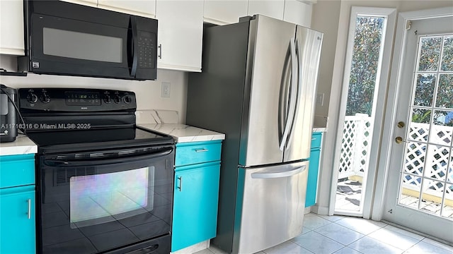 kitchen featuring white cabinets, light tile patterned flooring, and black appliances