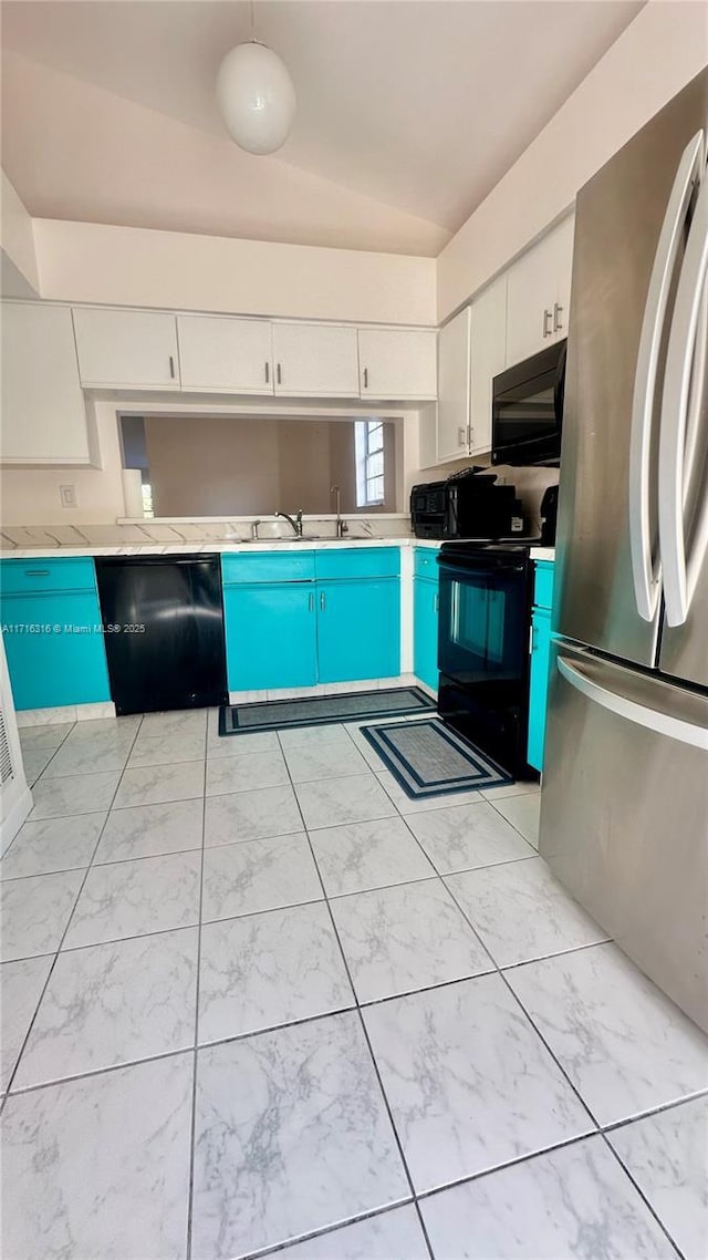 kitchen with black appliances, white cabinets, sink, and vaulted ceiling