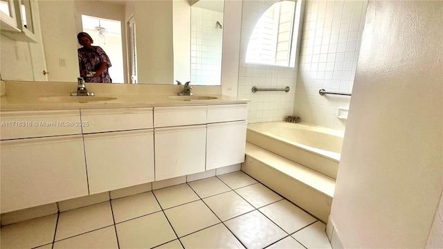 bathroom featuring vanity, a tub to relax in, tile patterned floors, and ceiling fan