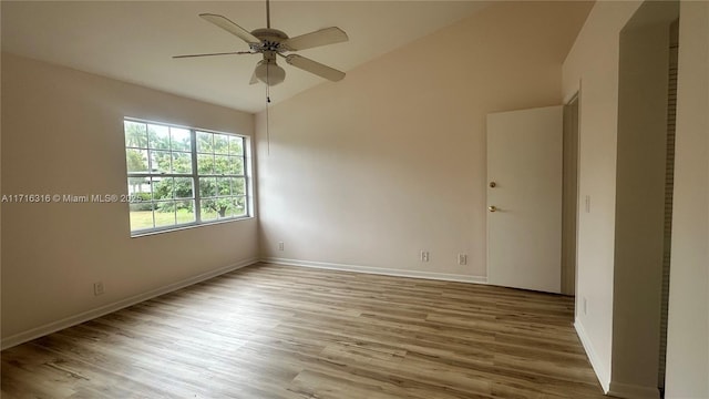 spare room featuring hardwood / wood-style floors, ceiling fan, and lofted ceiling