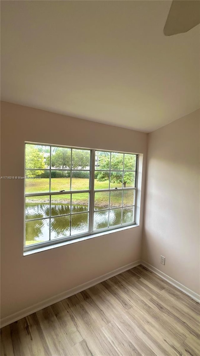 empty room with a water view and light wood-type flooring