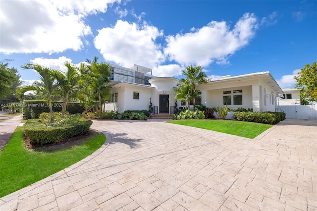 mediterranean / spanish home featuring a front lawn