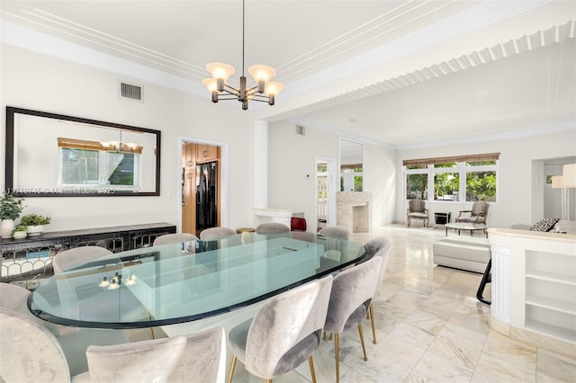 dining area with ornamental molding and an inviting chandelier