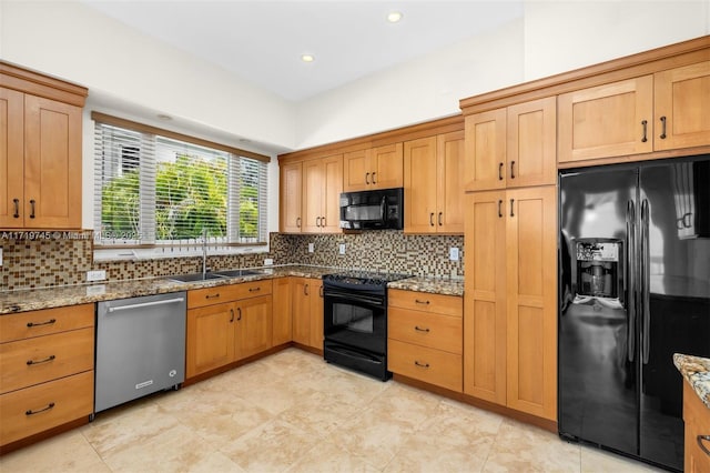 kitchen with decorative backsplash, sink, stone countertops, and black appliances