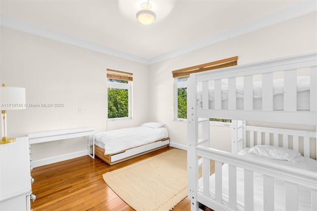 bedroom featuring hardwood / wood-style flooring and ornamental molding