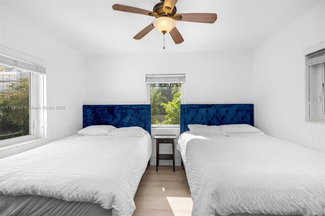 bedroom with ceiling fan and hardwood / wood-style flooring