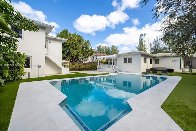 view of swimming pool with a lawn, a patio, and outdoor lounge area