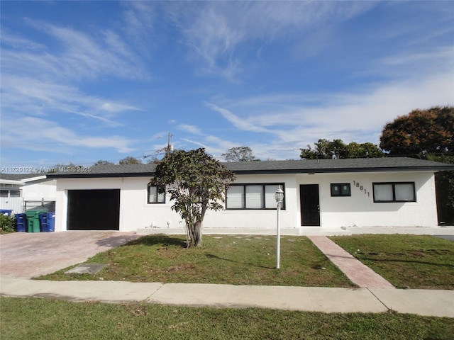 ranch-style home with a front yard and a garage