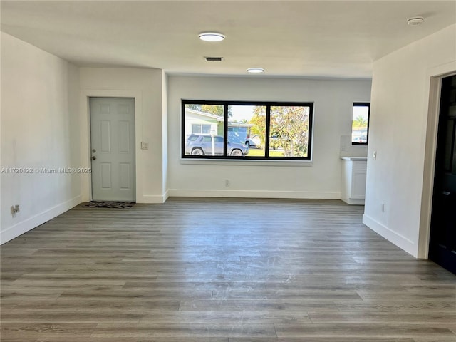 unfurnished living room featuring hardwood / wood-style floors