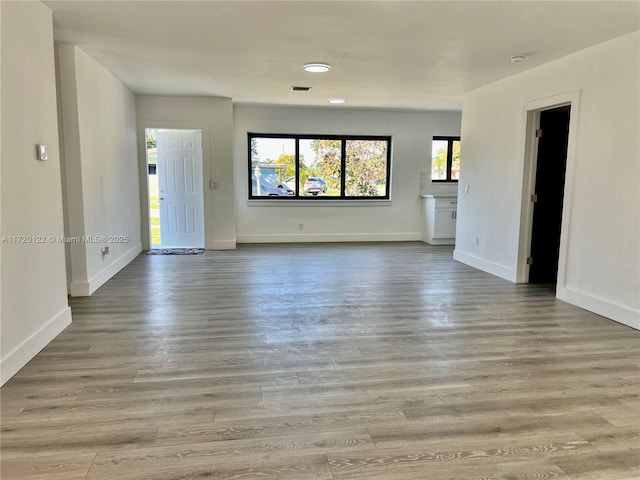 unfurnished living room featuring light wood-type flooring