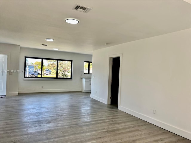 unfurnished living room with hardwood / wood-style flooring