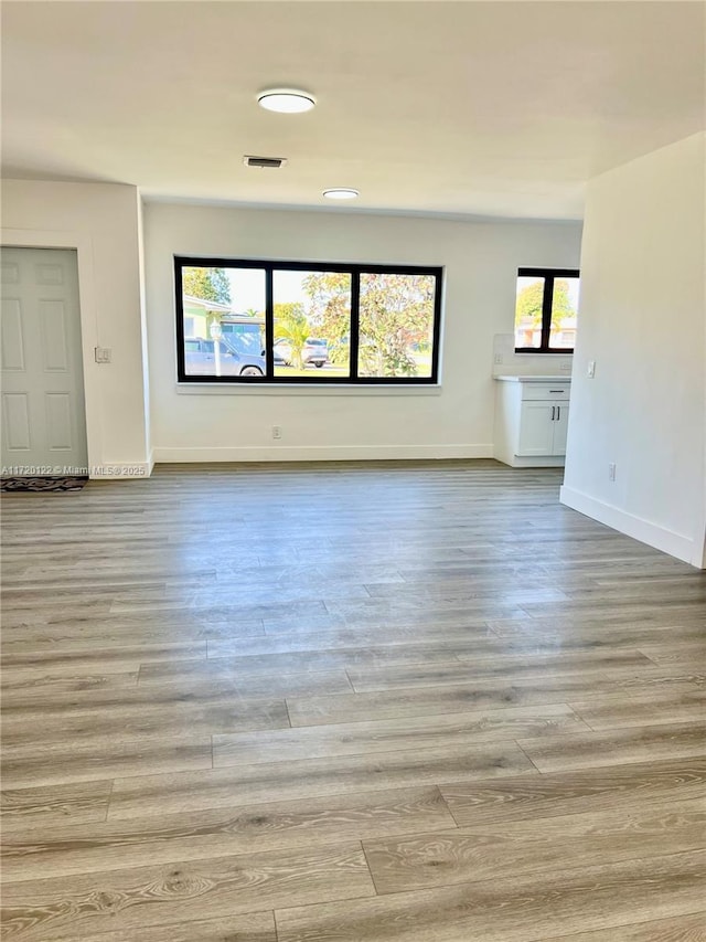 unfurnished living room with light wood-type flooring