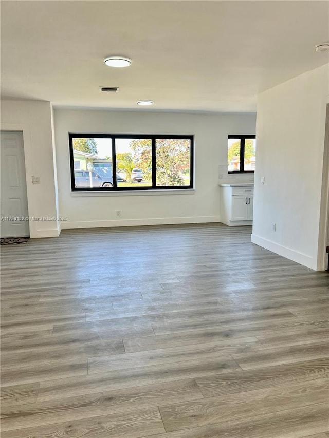 unfurnished living room with light wood-type flooring