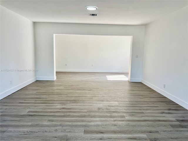 empty room with hardwood / wood-style flooring