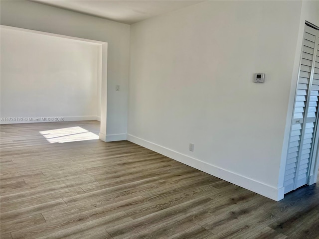 unfurnished room with hardwood / wood-style floors