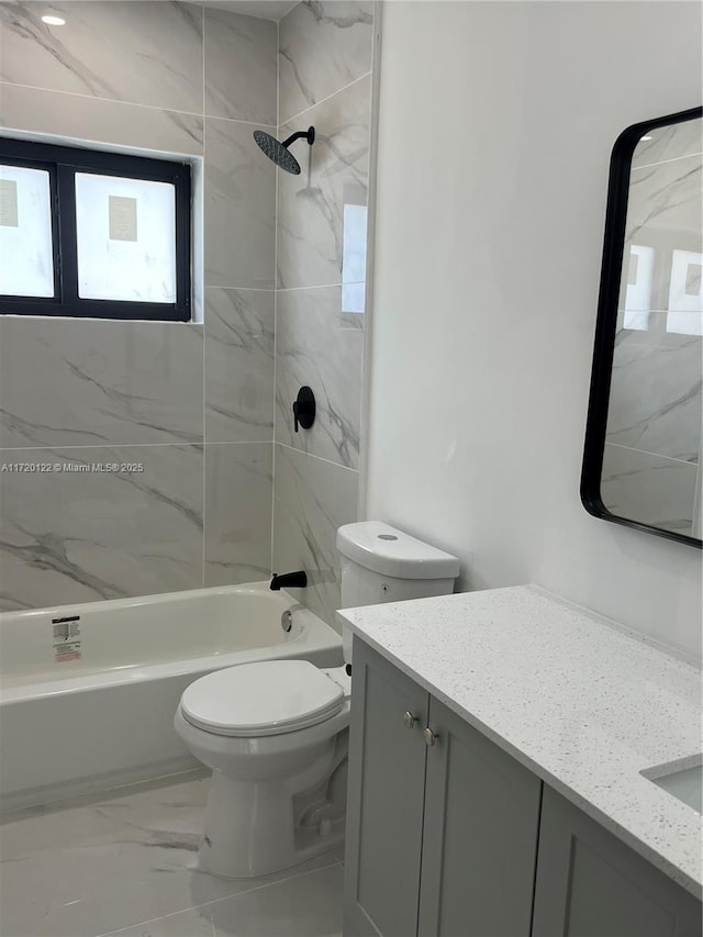 full bathroom featuring vanity, toilet, and tiled shower / bath combo