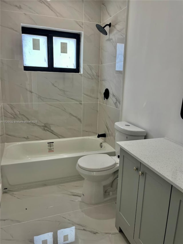 full bathroom with toilet, vanity, and tiled shower / bath