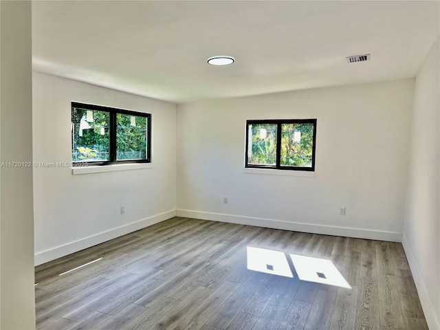 spare room with light hardwood / wood-style flooring