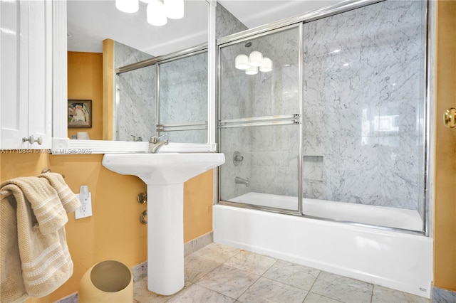 bathroom with tile patterned flooring and bath / shower combo with glass door