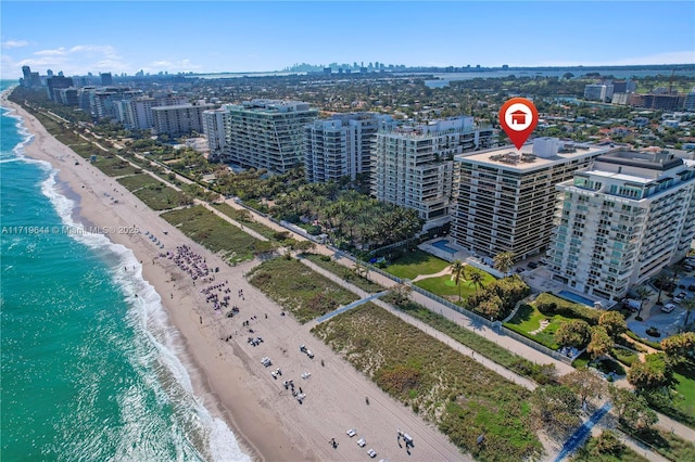 bird's eye view with a water view and a view of the beach