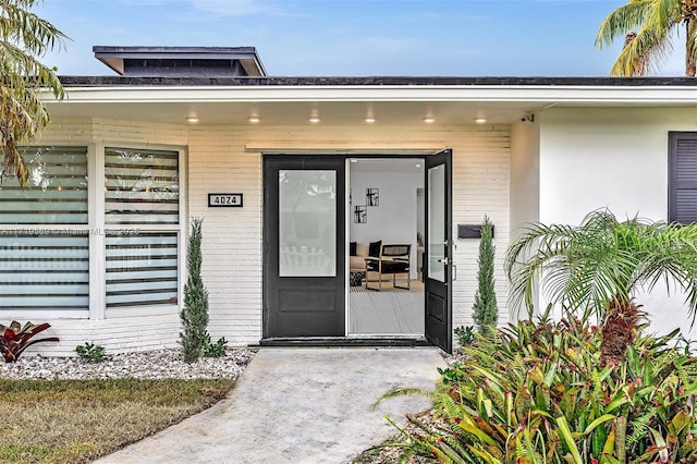 view of exterior entry with a porch