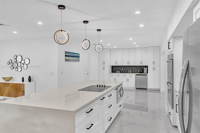 kitchen with a large island, tasteful backsplash, pendant lighting, white cabinets, and appliances with stainless steel finishes