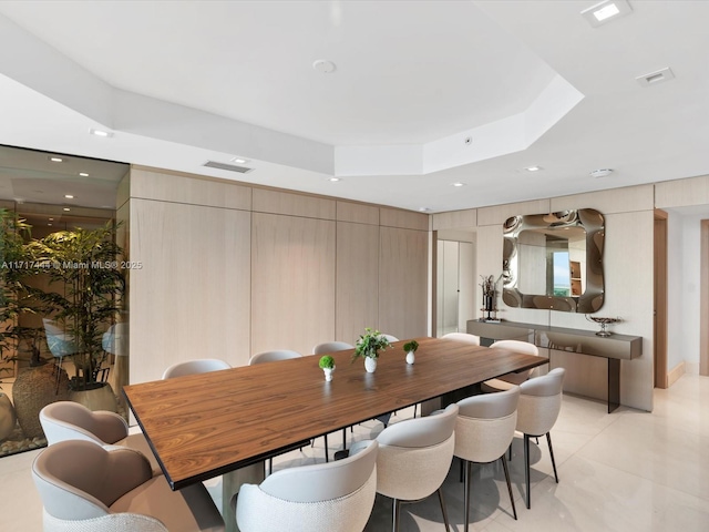 dining space featuring a raised ceiling