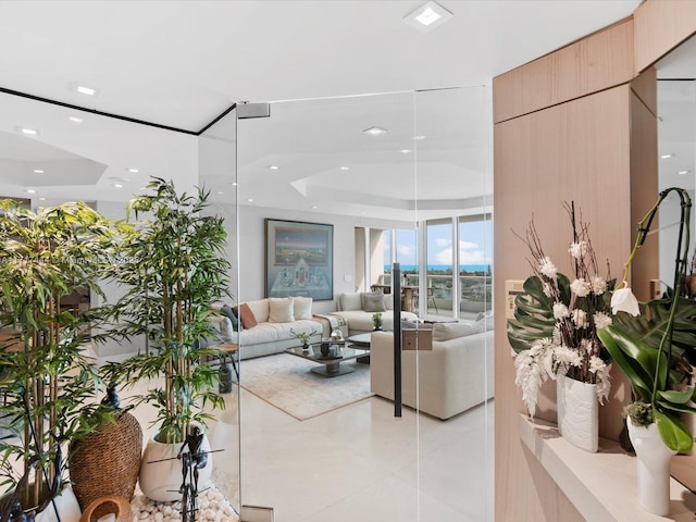 tiled living room with a raised ceiling