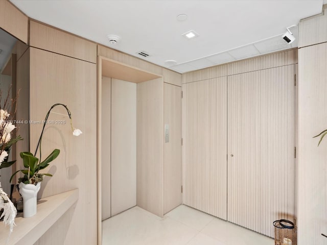 closet with elevator and visible vents