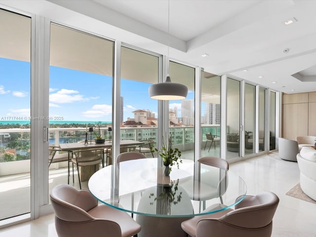 dining area featuring recessed lighting, a city view, and floor to ceiling windows