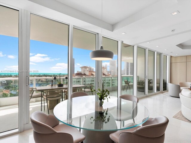 19955 NE 38th Ct Unit 1103, Aventura, FL 33180 - dining area featuring floor to ceiling windows and a raised ceiling