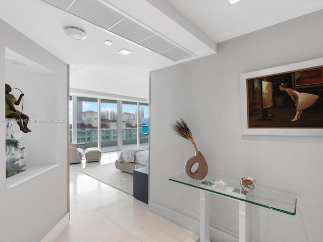 hallway with expansive windows and light tile patterned flooring